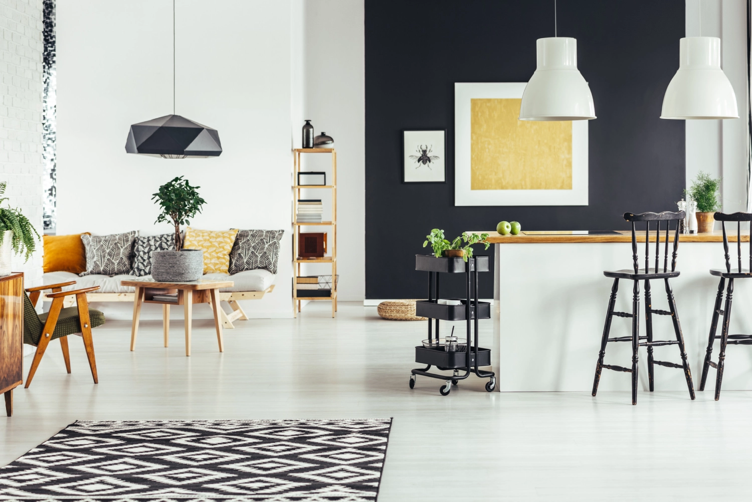 Geometric carpet in multifunctional chic living room with rustic bar stools at kitchenette<br />