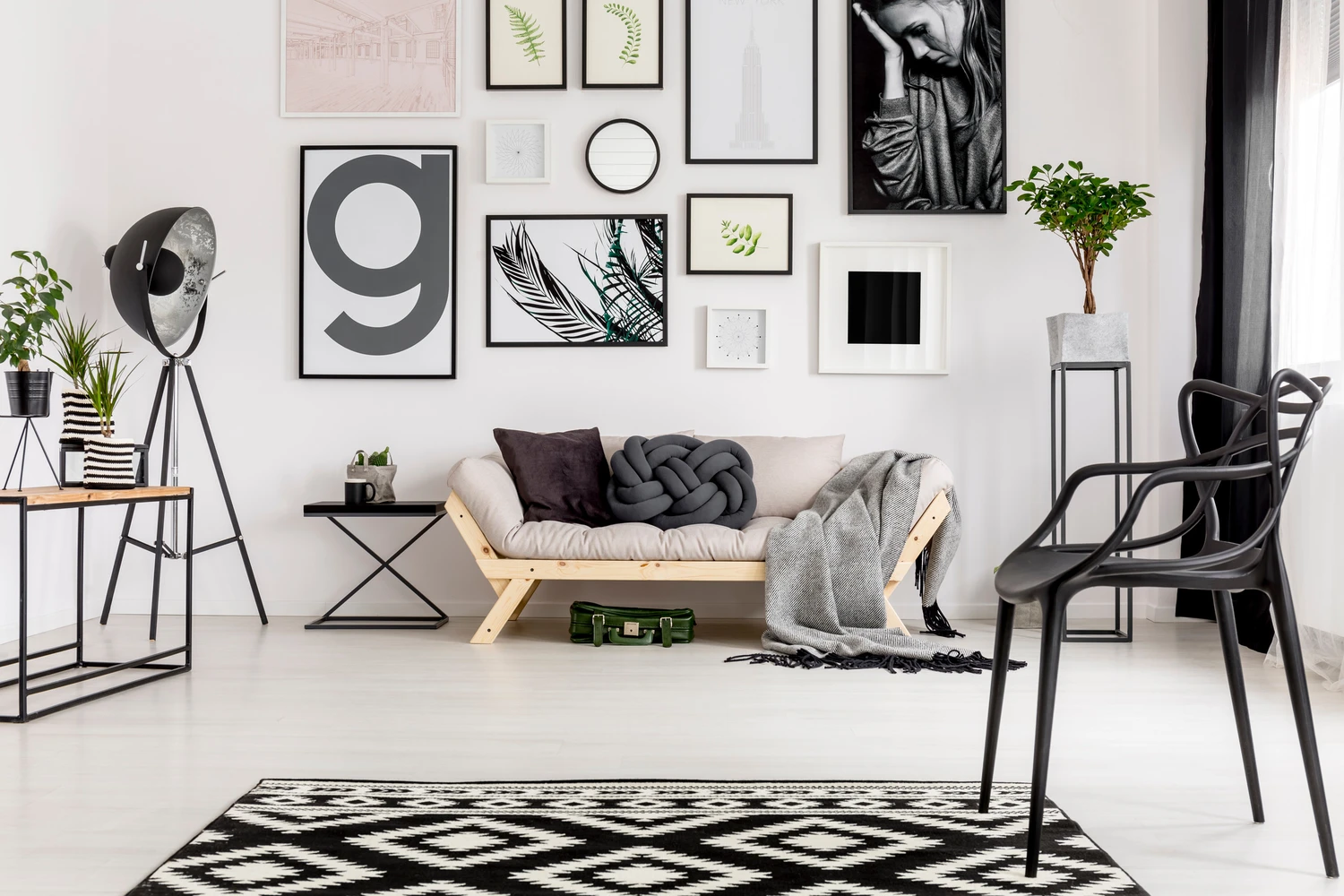 99295183_m (1) Comfy sofa with pillows, blanket, geometrical rug and posters in an artistic living room interior<br />